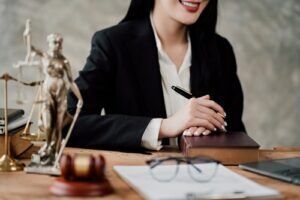 Criminal defense lawyer taking notes at her desk