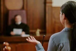 Woman addressing a judge in a courtroom