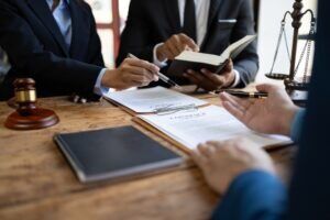 A team of lawyers discussing the legal defenses available in a manslaughter case