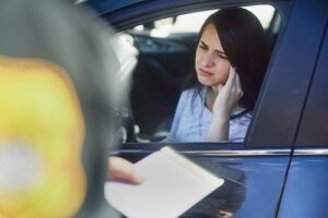 Upset woman in her car during a traffic stop