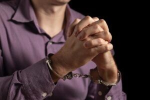A man with his hands clasped after being arrested. What are the penalties for manslaughter in Arizona?