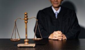 Judge seated behind the scales of justice