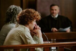 Worried defendant seated in a courtroom before a judge