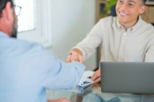 Client shaking hands with a smiling defense lawyer