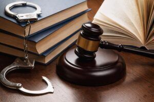A gavel, handcuffs, and law books representing a Tucson criminal defense case timeline.