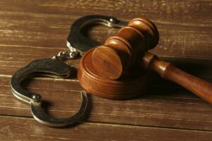 A judge’s gavel and handcuffs in a Phoenix violent crime charges case