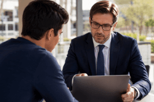 Phoenix criminal defense lawyer reviewing social media evidence with a client on a laptop