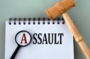 Assault concept with gavel. Learn the difference between threats and assault.