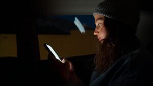 woman in an Uber on the Uber app for a blog post that discusses the number of Uber sexual assault lawsuits filed. 